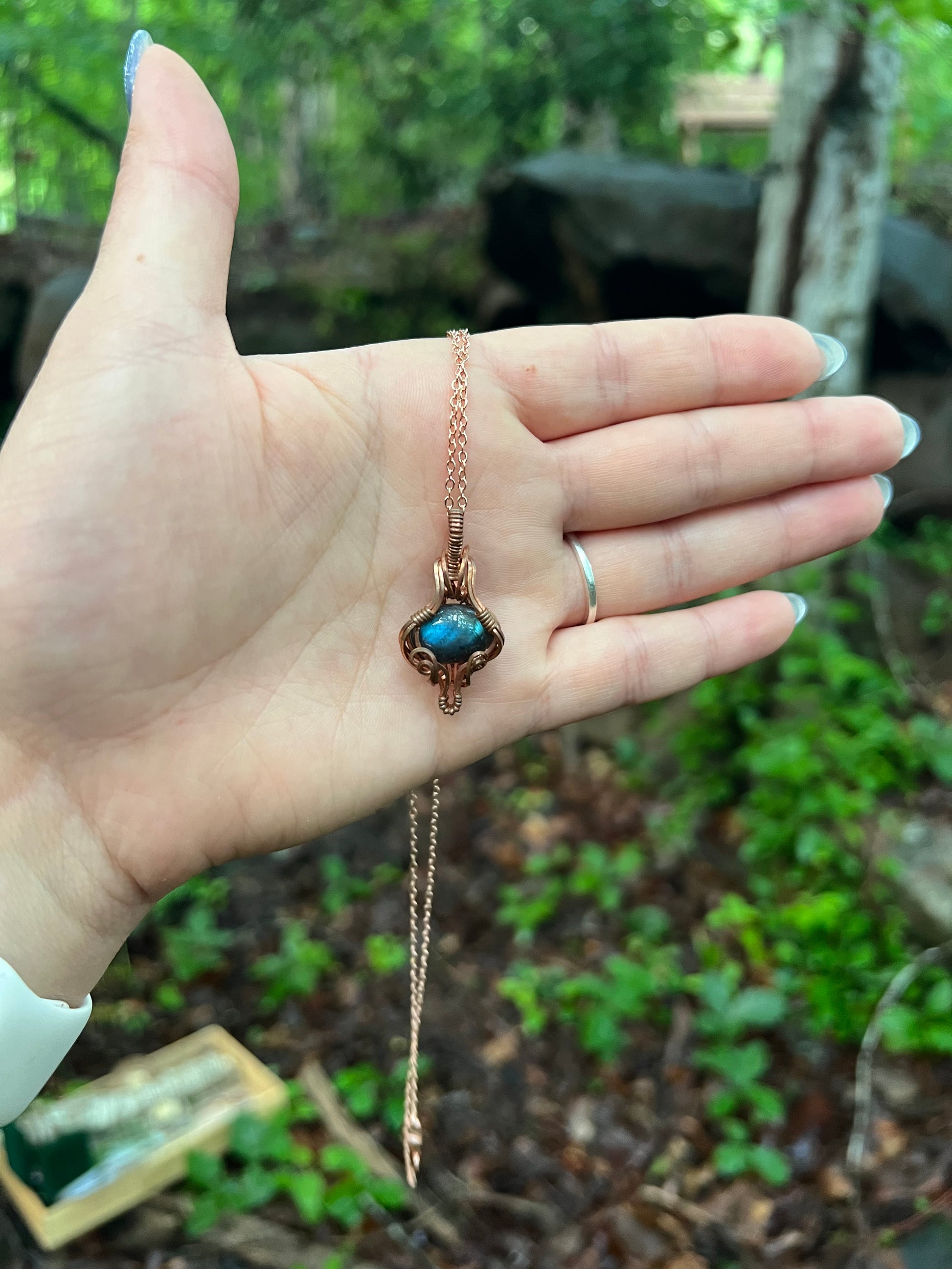 hand holding labradorite pendant