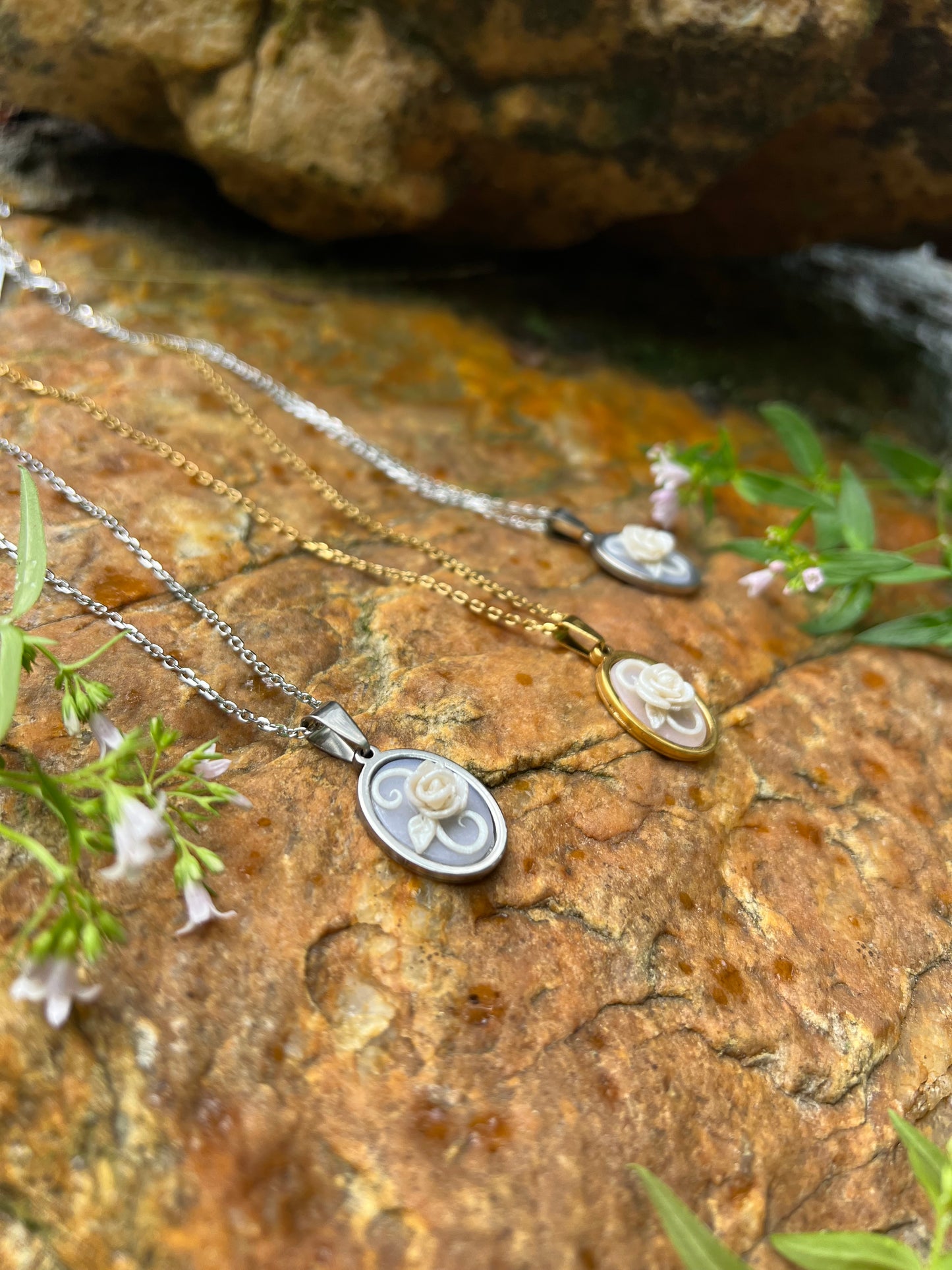 Hand sculpted white rose polymer clay necklace with stone background 