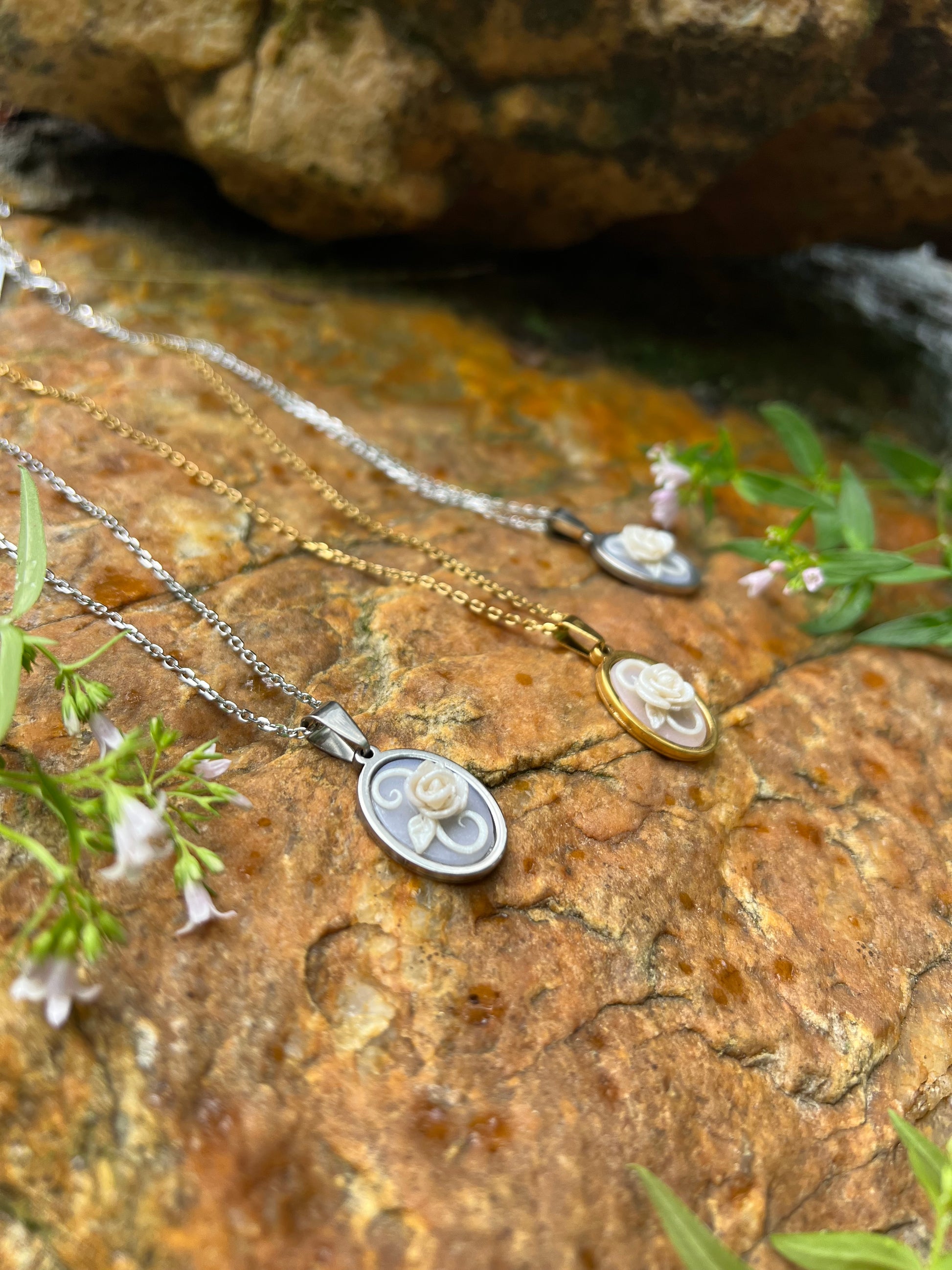 Hand sculpted white rose polymer clay necklace with stone background 