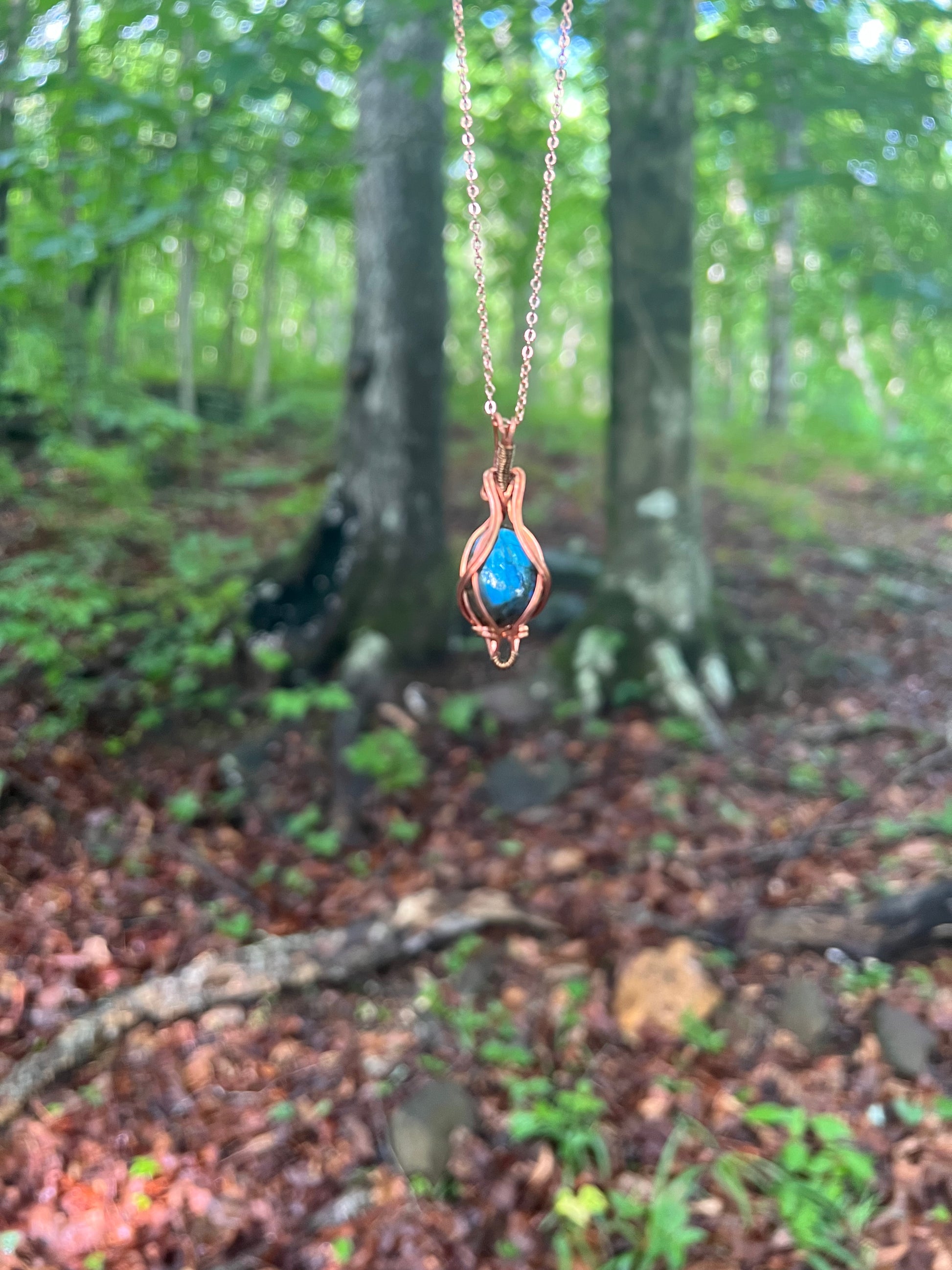 Wire Wrapped Blue Labradorite Necklace against a natural background
