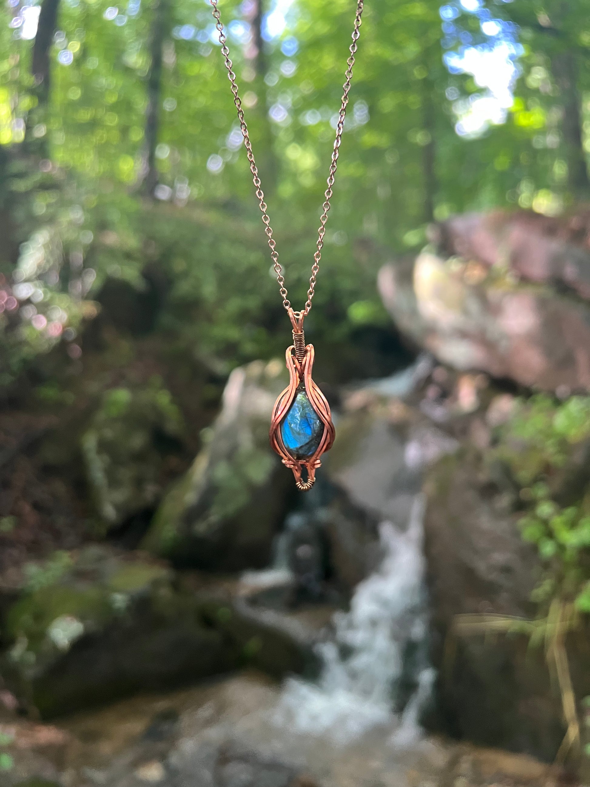 Wire Wrapped Blue Labradorite Necklace against a natural background
