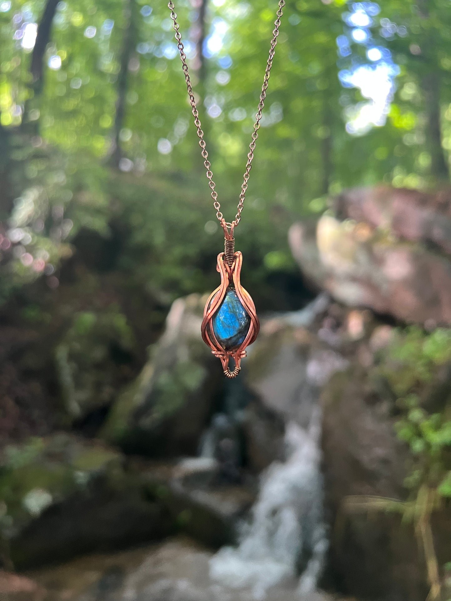 Necklace with a blue labradorite stone pendant against a natural background