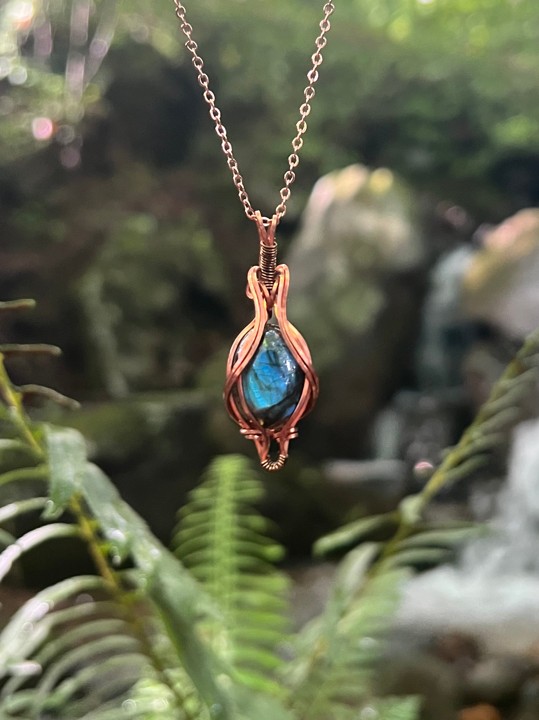 Wire Wrapped Blue Labradorite Necklace against a natural background