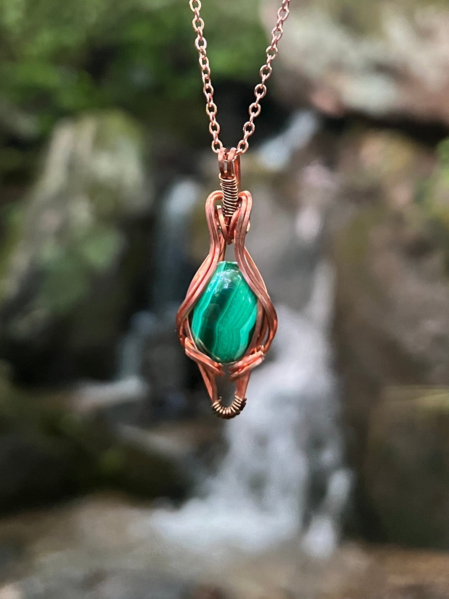Wire Wrapped Malachite and Copper Necklace against a natural background